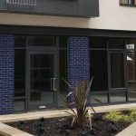 Grey aluminium shop front installation for new build project in Bristol