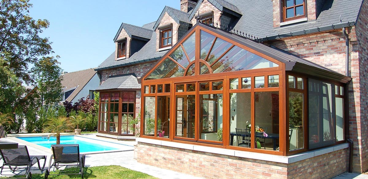 Brown aluminium conservatory with brick base