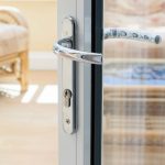 Bifolding door with polished chrome hardware supplied for homeowner