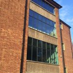Aluminium curtain wall installation for older commercial building