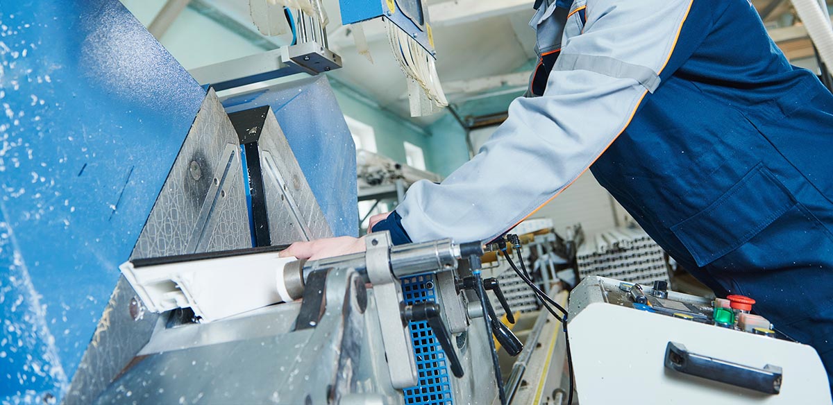 A factory worker manufacturing uPVC window