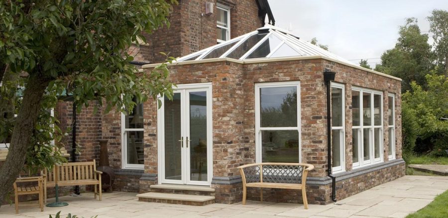 Large brick orangery structure with uPVC windows and roof system