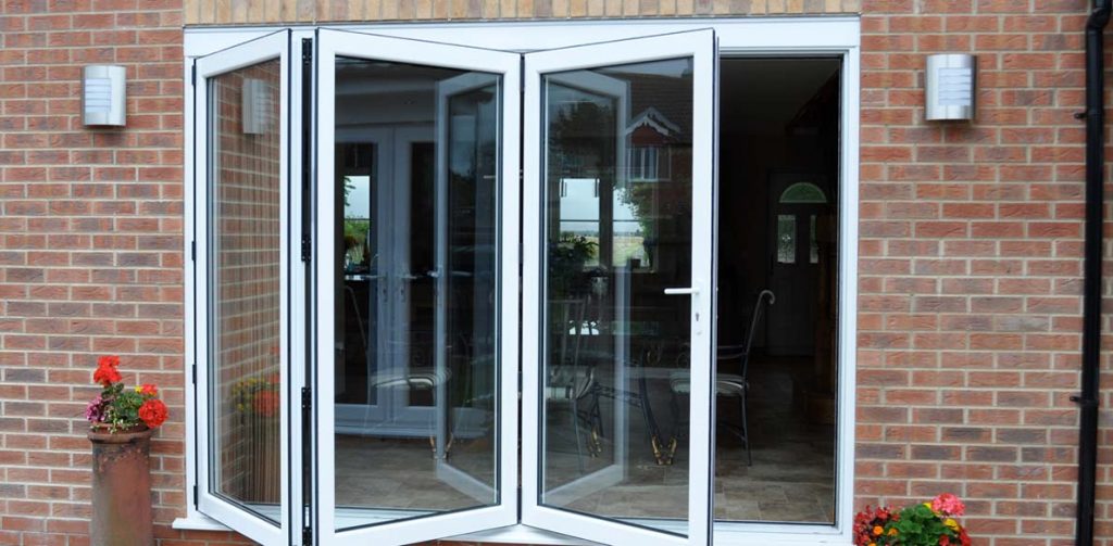 white bifold doors slightly open to show folding functionality