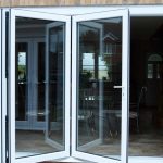white bifold doors slightly open to show folding functionality