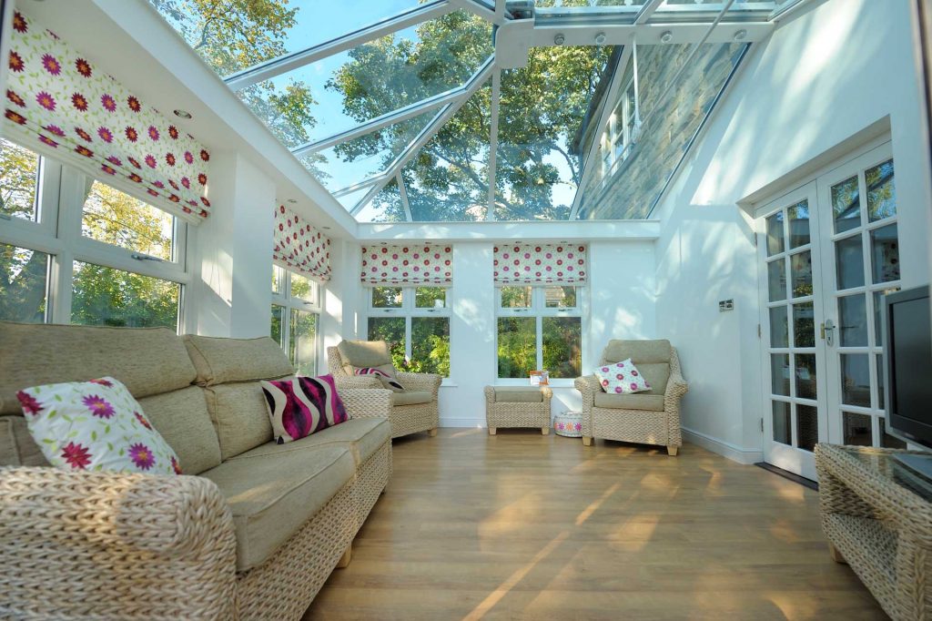 Internal view of a glazed orangery extension with modern interior