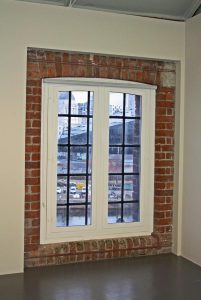 White secondary glazed unit fitted over old windows to make them more efficient