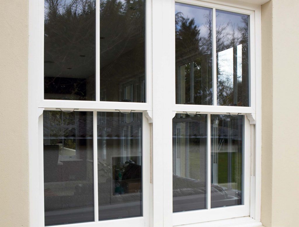 White vertical sliding sash window manufactured using Rehau uPVC