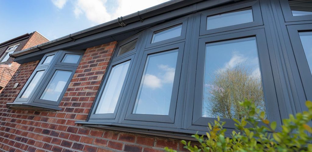 Grey timber look upvc window with a flush fitting mechanical joint